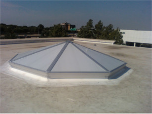 Exterior view of a white pyramid style CPI skylight over a store entrance
